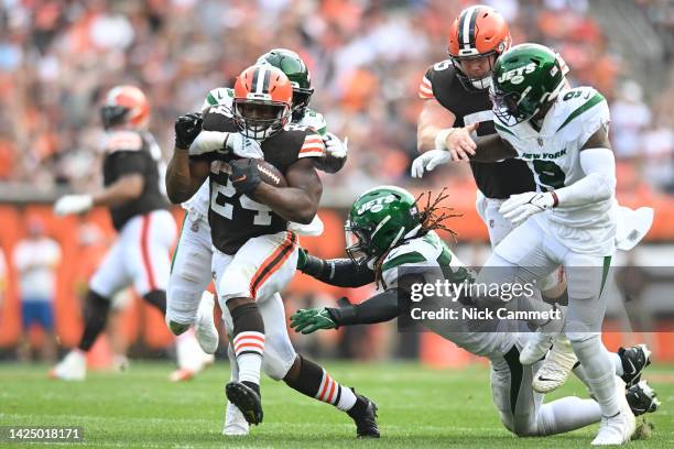 Nick Chubb of the Cleveland Browns runs with the ball while tackled by Jordan Whitehead and C.J. Mosley of the New York Jets during the second half...