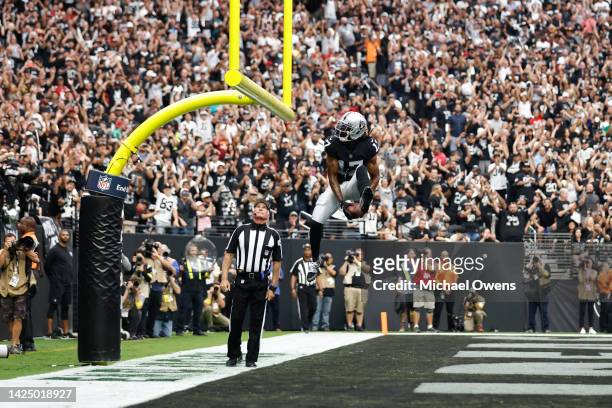 Davante Adams of the Las Vegas Raiders celebrates after scoring a touchdown against the Arizona Cardinals during the first half at Allegiant Stadium...