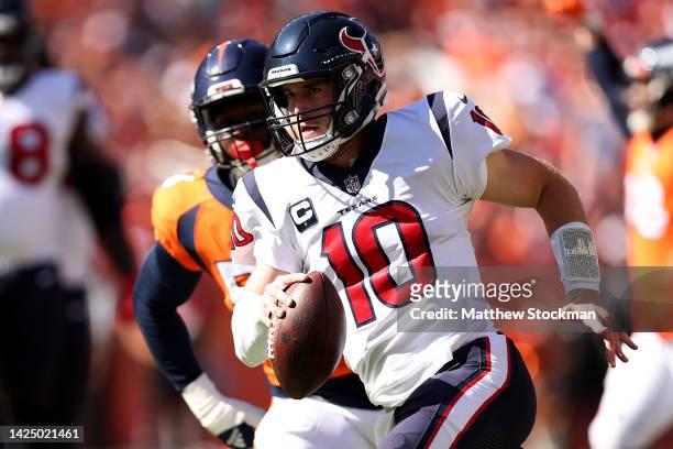 Davis Mills of the Houston Texans carries the ball in the second quarter of the game against the Denver Broncos at Empower Field At Mile High on...