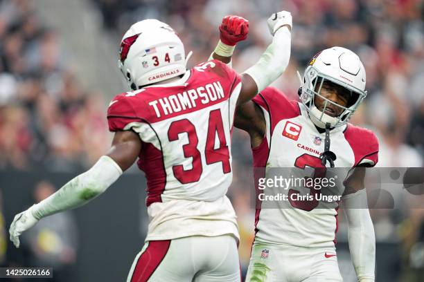 Jalen Thompson and Budda Baker of the Arizona Cardinals react after an incomplete pass in the third quarter against the Las Vegas Raiders at...