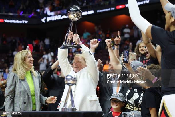 Las Vegas Aces owner Mark Davis hoists the trophy after the Aces defeated the Connecticut Sun 78-71 in game four to win the 2022 WNBA Finals at...