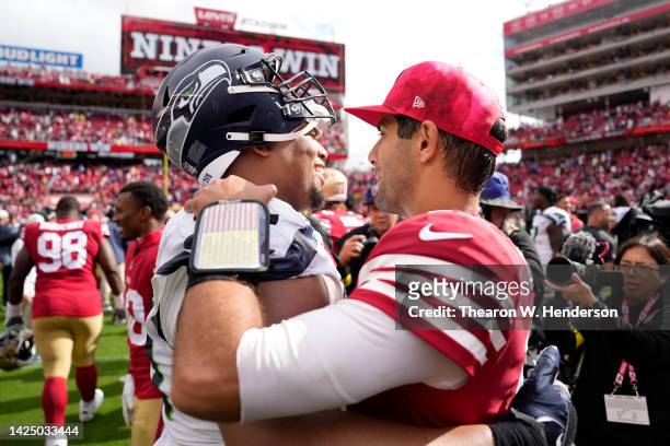 Al Woods of the Seattle Seahawks and Jimmy Garoppolo of the San Francisco 49ers embrace after the game at Levi's Stadium on September 18, 2022 in...