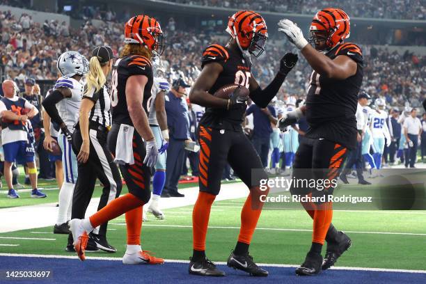 Tee Higgins of the Cincinnati Bengals is congratulated by La'el Collins after making a catch for a touchdown against the Dallas Cowboys during the...