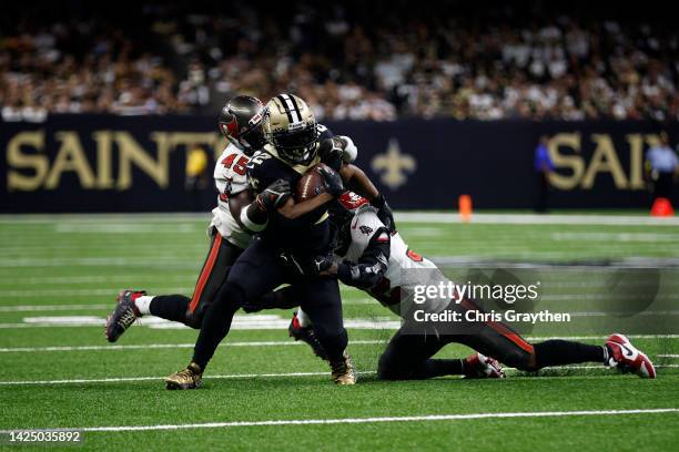 Mark Ingram II of the New Orleans Saints is tackled by Devin White of the Tampa Bay Buccaneers at Caesars Superdome on September 18, 2022 in New...