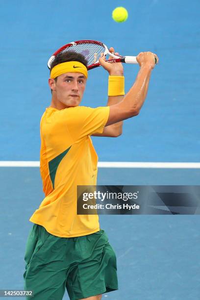 Bernard Tomic of Australia plays a backhand in his singles match against Min-Hyeok Cho of Korea on day one of the Davis Cup Asia Oceania Zone Second...