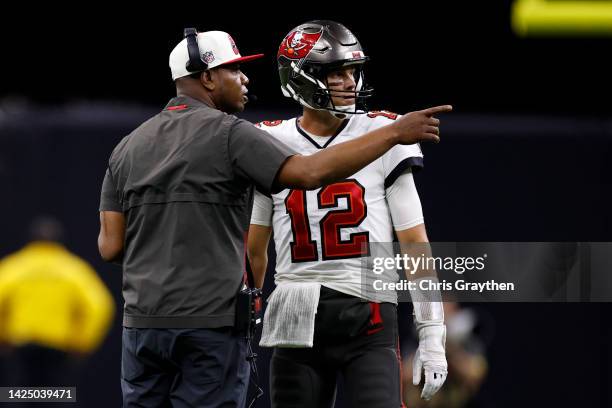 Tom Brady of the Tampa Bay Buccaneers talks with head coach Todd Bowles of the Tampa Bay Buccaneers during the game against the New Orleans Saints at...