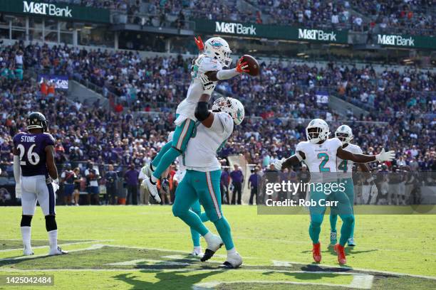 Wide receiver Jaylen Waddle of the Miami Dolphins celebrates after catching a touchdown pass late in the fourth quarter against the Baltimore Ravens...
