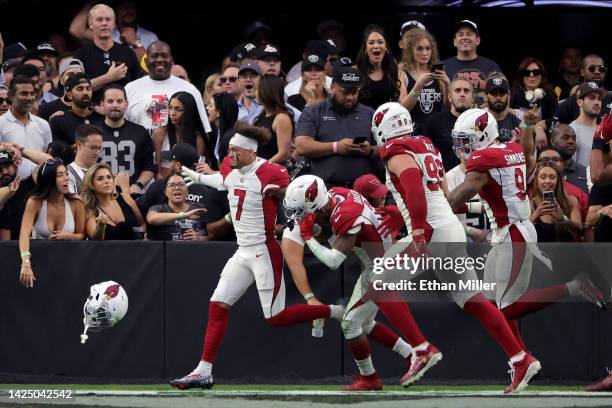 Byron Murphy Jr. #7 of the Arizona Cardinals celebrates with teammates after returning a fumble for a game-winning touchdown in overtime against the...