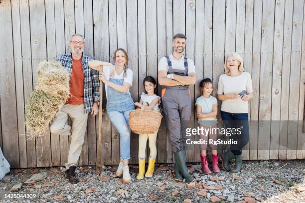 portrait of a happy family, together on their ranch - farm wife stock pictures, royalty-free photos & images