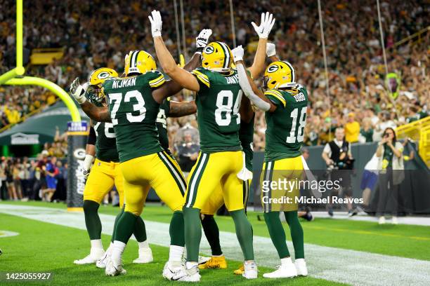 Aaron Jones and the Green Bay Packers celebrate after a touchdown during the second quarter in the game against the Chicago Bears at Lambeau Field on...