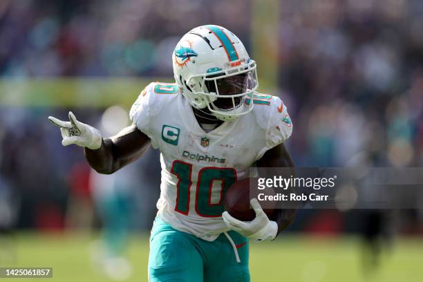 Wide receiver Tyreek Hill of the Miami Dolphins celebrates while scoring his second pass touchdown against the Baltimore Ravens at M&T Bank Stadium...