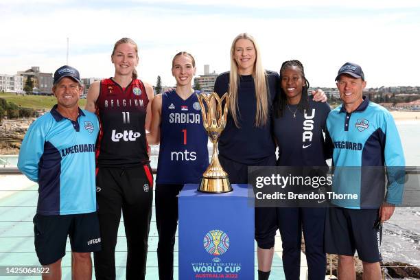 Emma Meesseman of Belgium, Ivana Raca of Serbia, Lauren Jackson of Australia and Ariel Atkins of USA pose with Bondi lifeguards Corey Oliver and...