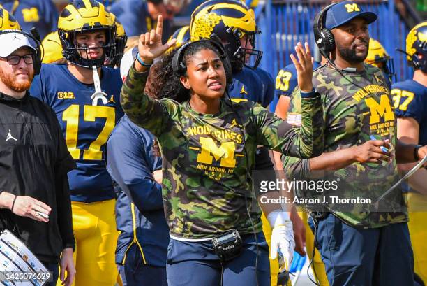 Graduate Assistant Coach Mimi Bolden-Morris of the Michigan Wolverines signals a play during the second half of a college football game at Michigan...