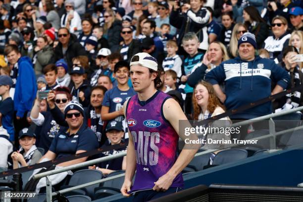 Max Holmes of the Cats runs out before a Geelong Cats AFL training session at GMHBA Stadium on September 19, 2022 in Geelong, Australia.