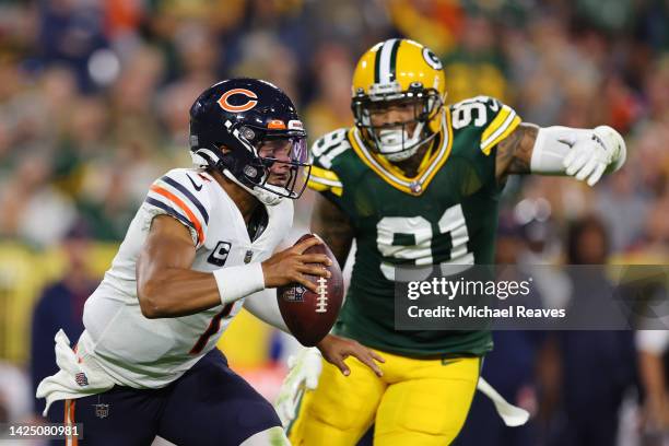 Justin Fields of the Chicago Bears is chased by Preston Smith of the Green Bay Packers during the fourth quarter at Lambeau Field on September 18,...