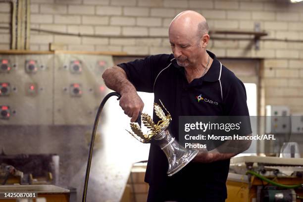 Vin Formosa completes the final touches as the 2022 AFL Premiership Cup Returns to Cash's Trophies To Get Its Final Polish Ahead of AFL Grand Final...