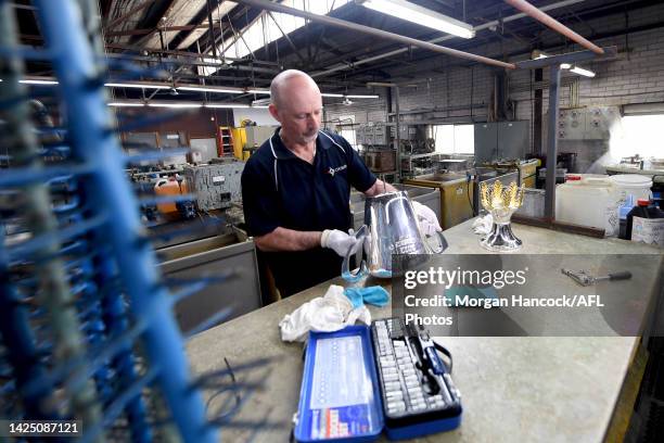 Vin Formosa completes the final touches as the 2022 AFL Premiership Cup Returns to Cash's Trophies To Get Its Final Polish Ahead of AFL Grand Final...