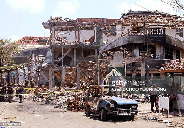 Australian and Indonesian flags are hanging on a damaged building by a bomb blast site in the tourist district of Kuta in Denpasar,Bali 16 October...