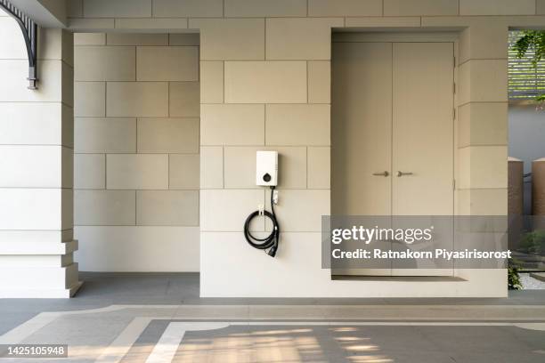 pod point domestic home electric vehicle charging point mounted on a brick wall with copy space. - electric car home stock pictures, royalty-free photos & images