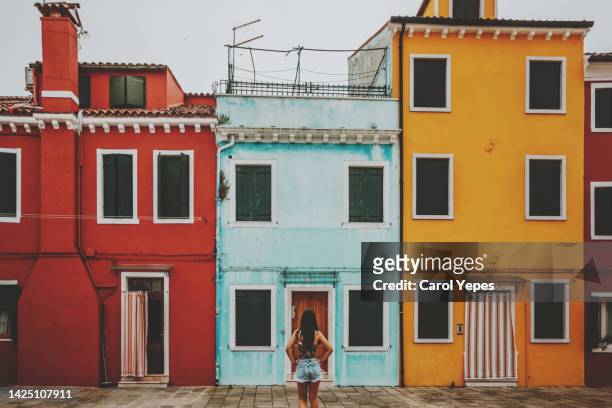 young tourist exploring colorful buildings in burano italy - burano fotografías e imágenes de stock