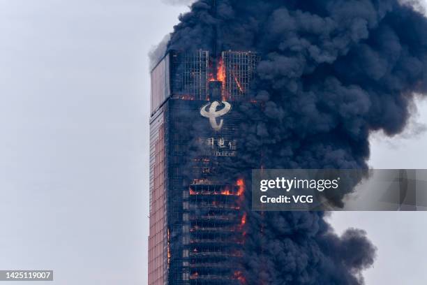 Thick smoke billows from a high-rise building belonging to China Telecom on September 16, 2022 in Changsha, Hunan Province of China. A major fire...