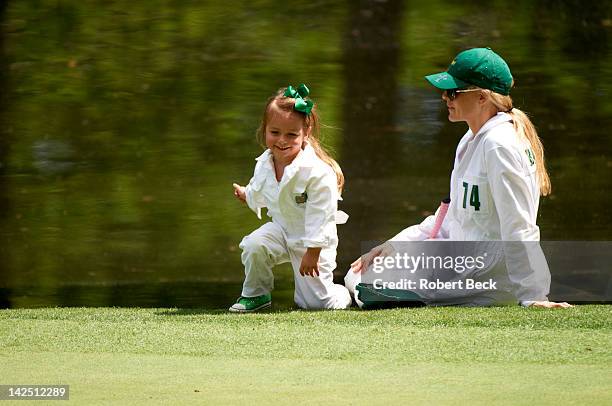 Masters Preview: Richelle Baddeley, wife of Aaron Baddeley, with their daughter during Par 3 tournament on Wednesday at Augusta National. Augusta, GA...