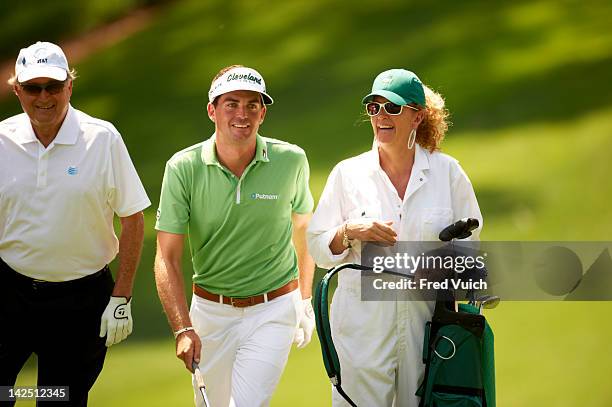 Masters Preview: Keegan Bradley with his mother, serving as caddie during Par 3 tournament on Wednesday at Augusta National. Augusta, GA 4/4/2012...