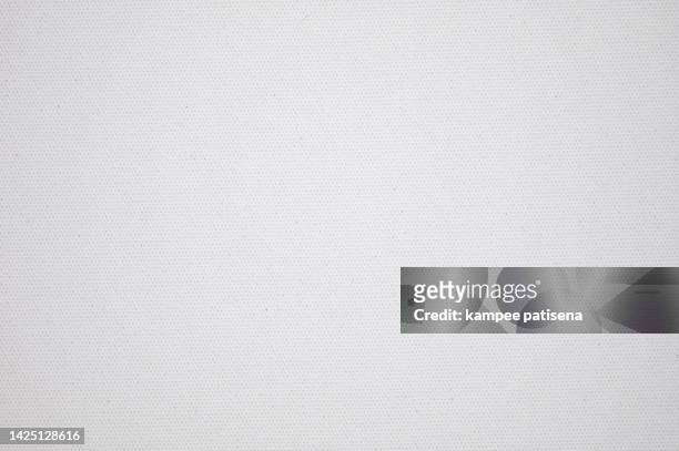 close up of a white textured paper background - canvas fabric - fotografias e filmes do acervo