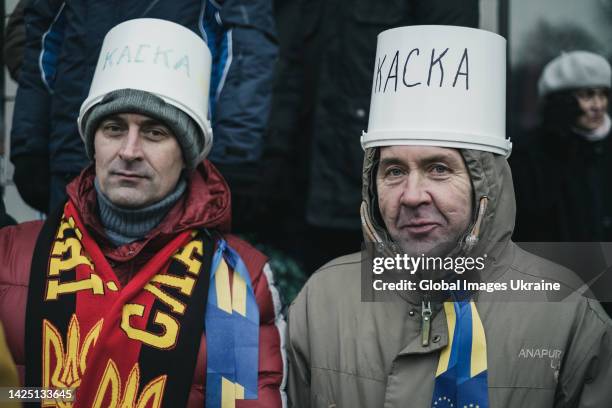 Protesters wearing the buckets signed “Helmet” are seen during anti-government protest in the center of the Ukrainian capital on January 19, 2014 in...