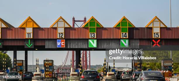 Cars go by toll booths at Almada's end of the 25 de Abril Bridge on September 18, 2022 in Lisbon, Portugal. The 25 de Abril Bridge is a suspension...