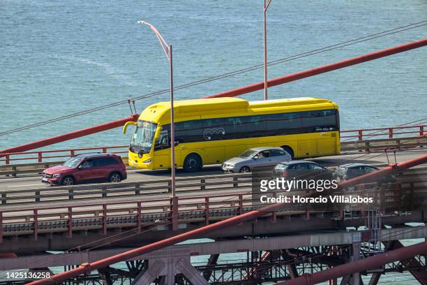 Carris Metropolitana bus and cars circulate on the 25 de Abril Bridge crossing the Tagus River on September 18, 2022 in Lisbon, Portugal. The 25 de...