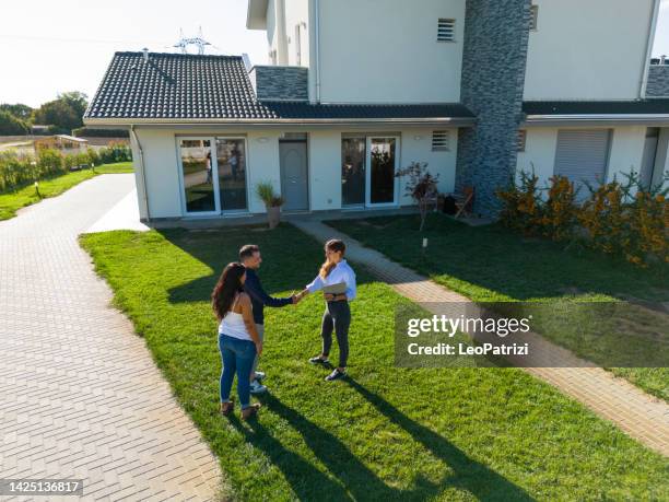 young couple just aquired a new property - sold house stock pictures, royalty-free photos & images