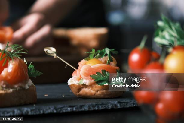 making salmon bites - canape stock pictures, royalty-free photos & images