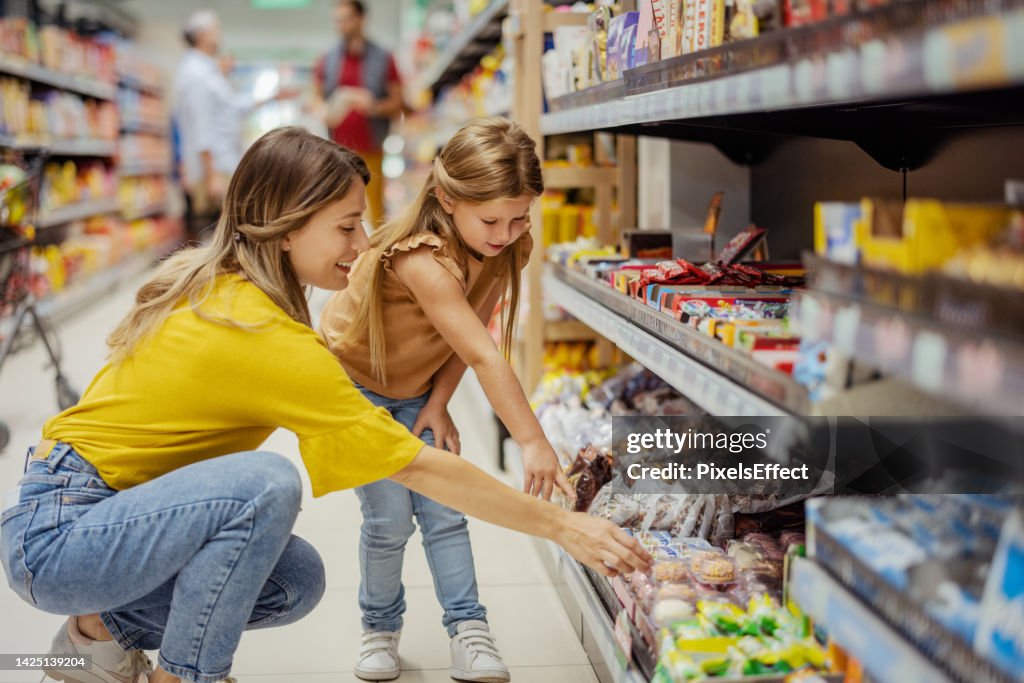 Mother and Girl Daughter in the Supermarket