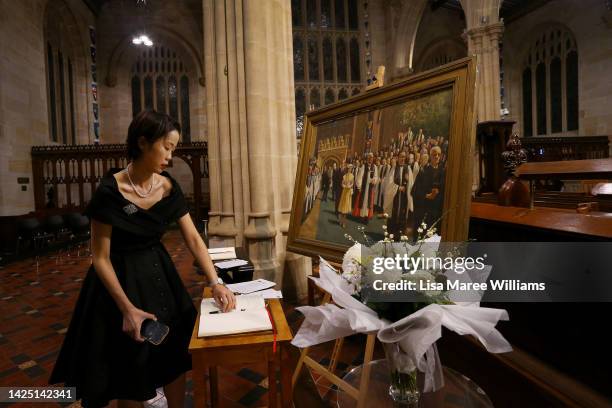 Fiona Wong leaves a message of condolence for herself and family in Hong Kong for Queen Elizabeth II at St. Andrew's Cathedral on September 19, 2022...