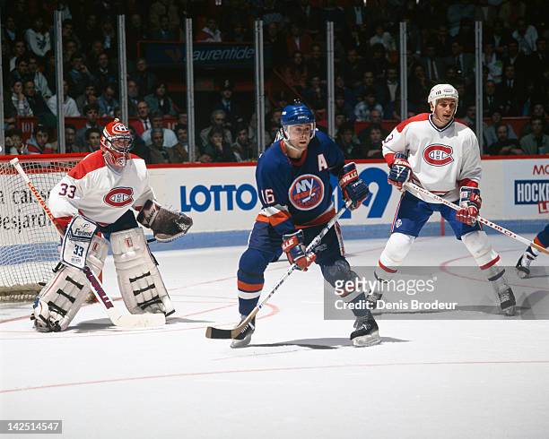 Pat Lafontaine of the New York Islanders skates in front of Patrick Roy of the Montreal Canadiens Circa 1980 at the Montreal Forum in Montreal,...