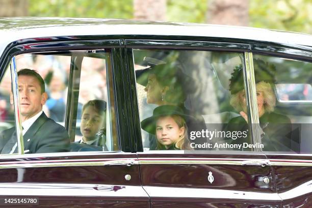 Prince George of Wales, Princess Charlotte of Wales, Catherine, Princess of Wales and Camilla, Queen consort are seen on The Mall ahead of The State...