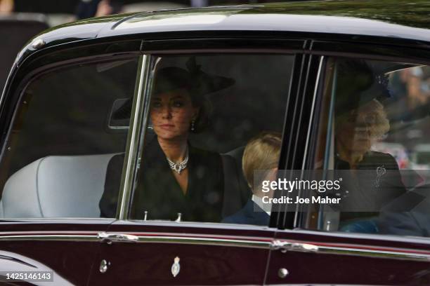 Catherine, Princess of Wales, Camilla, Queen Consort and Prince George of Wales are seen on The Mall ahead of The State Funeral for Queen Elizabeth...