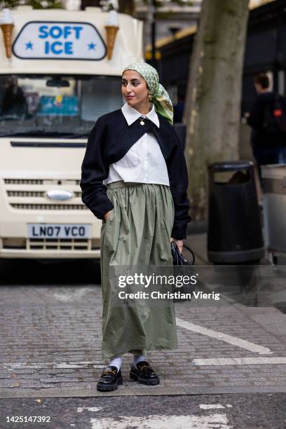 Guest wears green skirt outside Erdem during London Fashion Week September 2022 on September 18, 2022 in London, England.