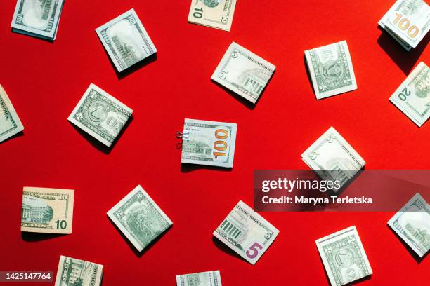 dollars on a red background. money. currency. inflation. world crisis. - dollars foto e immagini stock