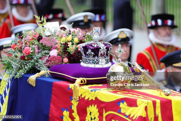 The coffin of Queen Elizabeth II with the Imperial State Crown resting on top is carried into Westminster Abbey on September 19, 2022 in London,...