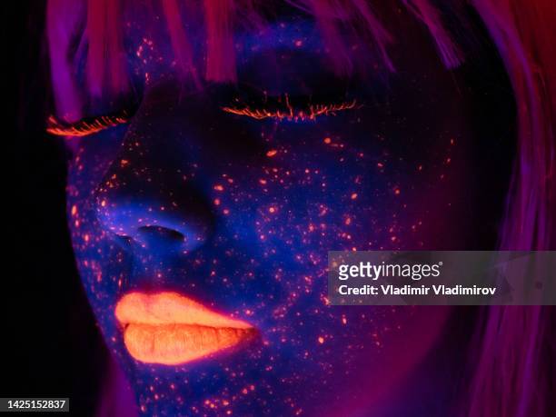 portrait painted with fluorescent makeup under the ultraviolet light - cyber punk girl stock pictures, royalty-free photos & images