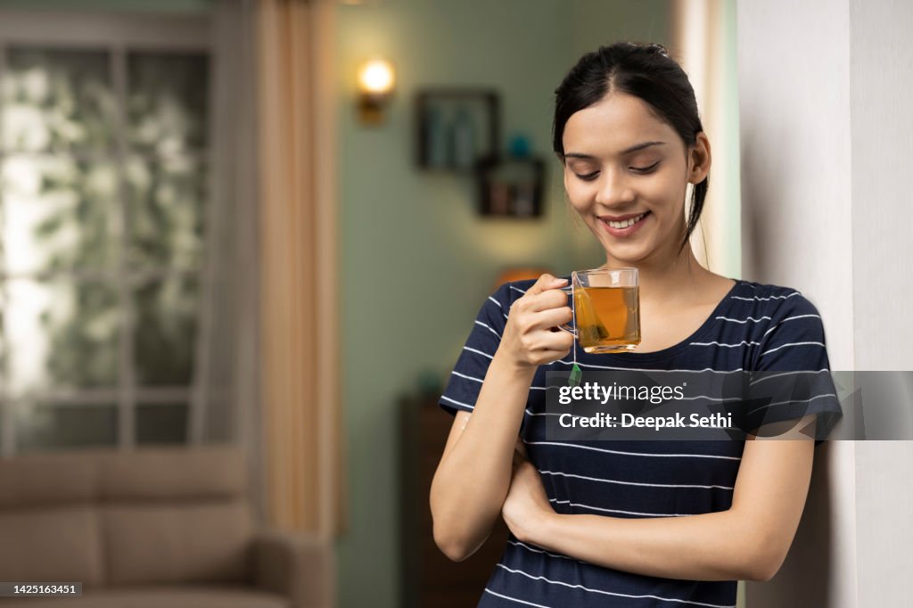 Young woman drinking green tea, stock photo