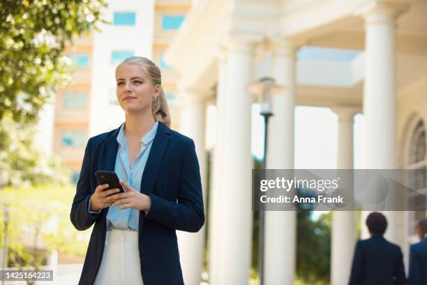 a young business woman on the phone in the city - platinum stock pictures, royalty-free photos & images