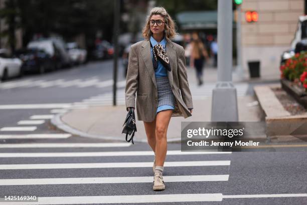 Guest seen wearing a beige outfit with blazer and skirt outside Coach during New York Fashion Week on September 12, 2022 in New York City.