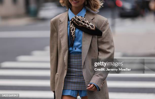 Guest seen wearing a beige outfit with blazer and skirt outside Coach during New York Fashion Week on September 12, 2022 in New York City.