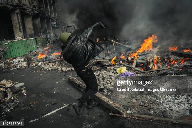 Protester fighting government forces at burning barricades on Maidan Nezalezhnosti on February 19, 2014 in Kyiv, Ukraine. A wave of civil protests,...