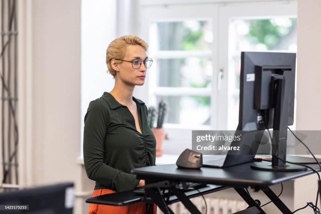 Businesswoman working at her standing desk at startup office