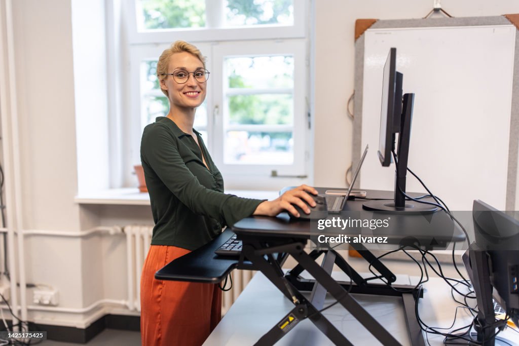 Portrait of a businesswoman working at her standing desk at startup office