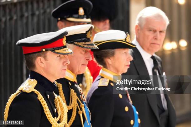 King Charles III, Anne, Princess Royal and Prince Andrew, Duke of York watch on as The Queen's funeral cortege borne on the State Gun Carriage of the...